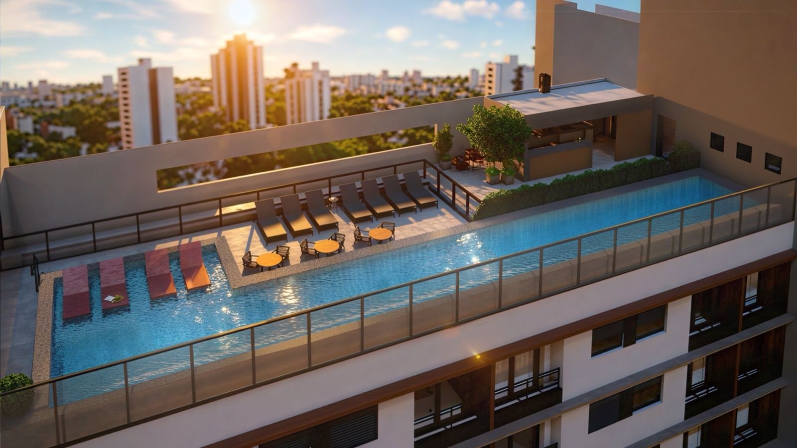 Vista aérea da piscina na cobertura do Bracon Quatá, na Vila Olímpia, com a cidade ao fundo no fim de tarde