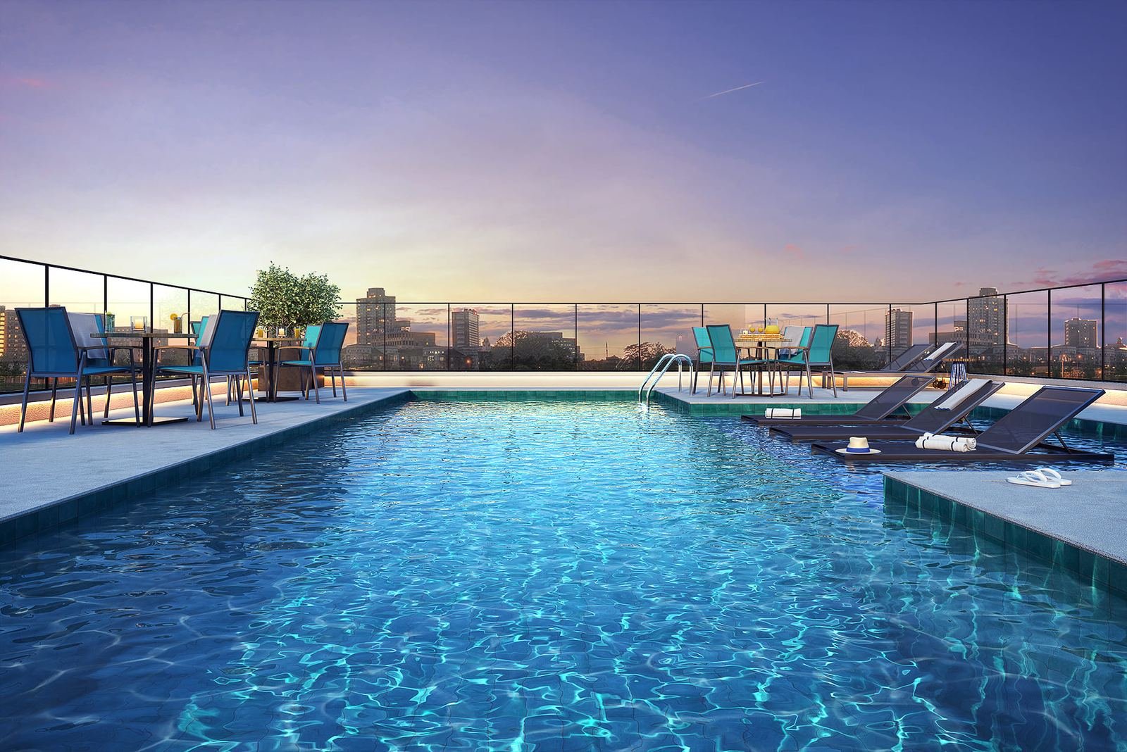 Rooftop com piscina do Bracon Faria Lima ao entardecer, com os prédios de Pinheiros ao fundo