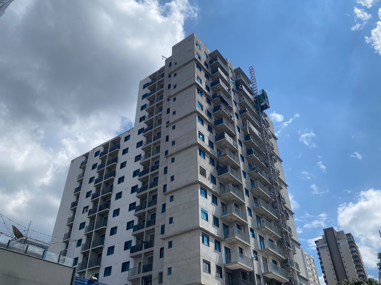Foto da obra em 28 de setembro de 2026: a torre vista da rua, com fachada e esquadrias instaladas